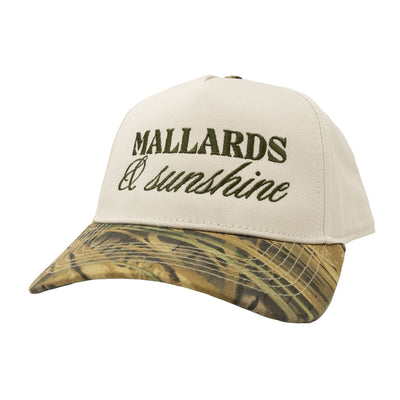 The Maggie Mallards Sunshine Hat by Higdon Outdoors features "MALLARDS & sunshine" embroidered in green on the front, a beige crown, and a green camouflage-patterned brim.