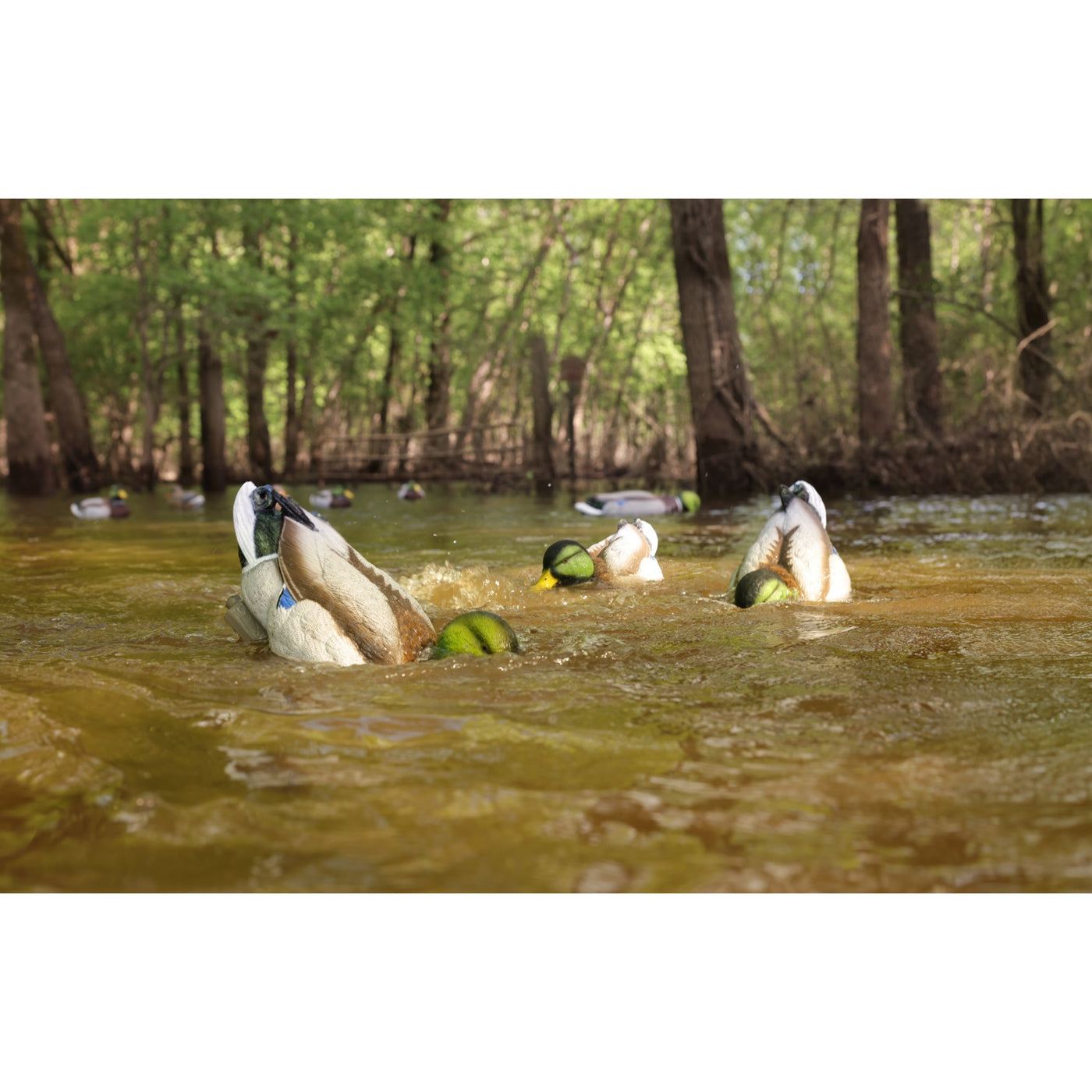 The Higdon Outdoors Motion Machine, a black tripod device with three angled legs and wire attachments, lies on the ground—an ideal water motion tool for boosting your decoy spread—shown against a white background.