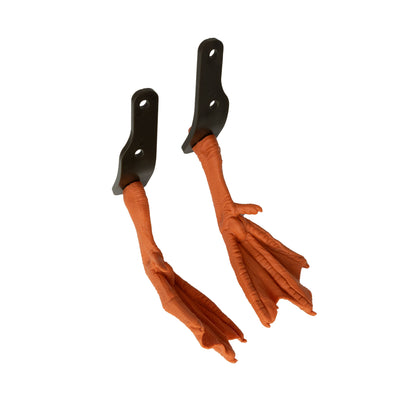 A pair of orange, realistic bird feet made of plastic or rubber, each mounted on a black metal bracket with two screw holes—Higdon Outdoors PRO Series Feet (pair), perfect as replacement parts for your Pulsator Pro.